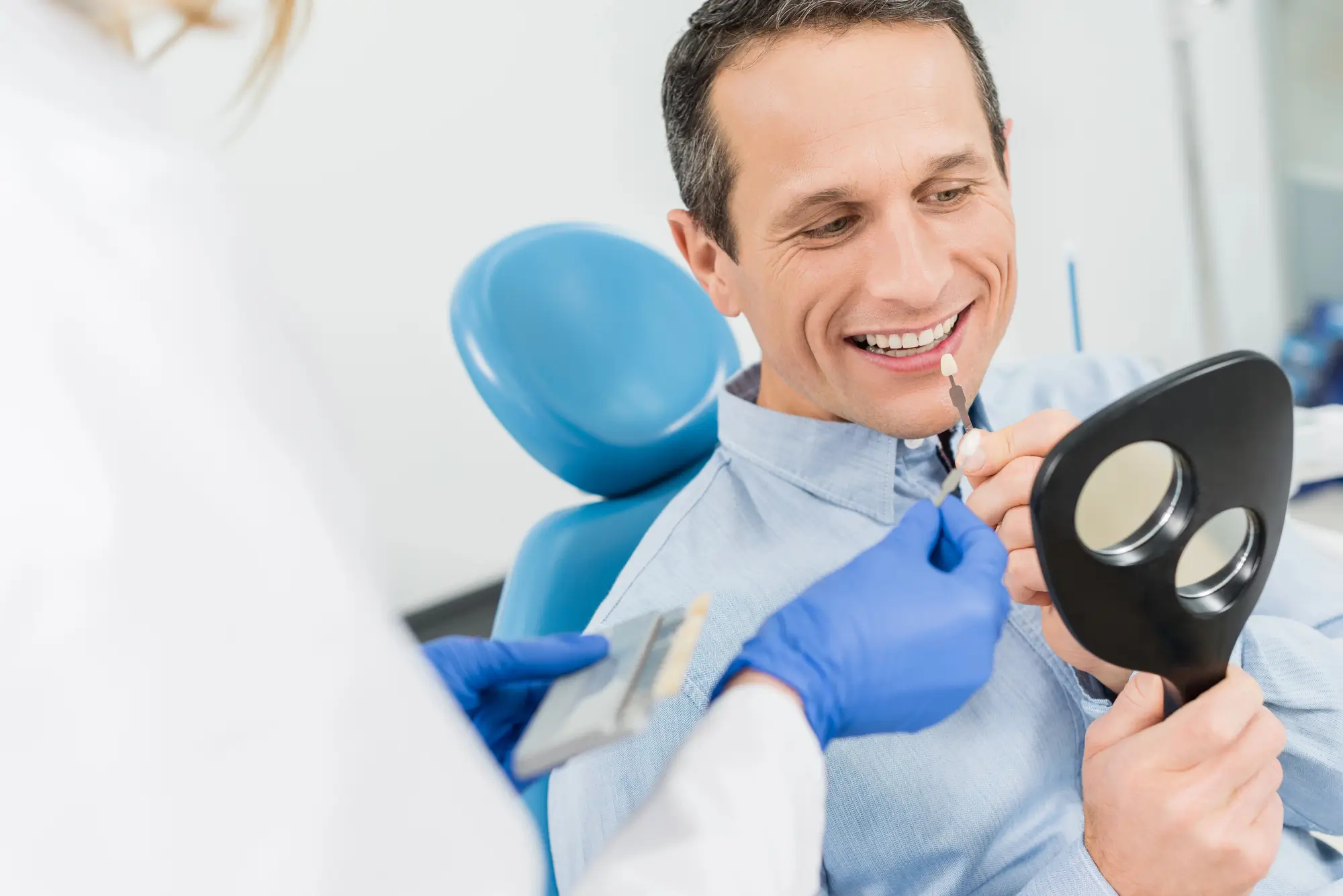 Patient Choosing Dental Implants In Plymouth While Looking In A Mirror